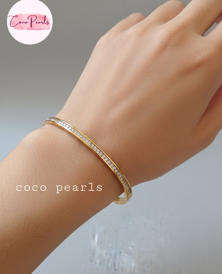 Coco Pearls Stainless Steel Anti tarnish Gold crystal shine handcuff bracelet with diamonds on a wrist