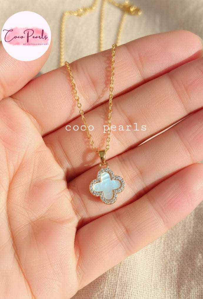 Coco Pearls Stainless Steel Anti Tarnish Two sided diamond studded gold necklaces with clover-shaped pendants one side black one side white on hand