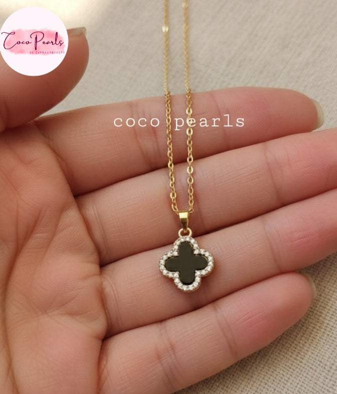 Coco Pearls Stainless Steel Anti Tarnish Two sided diamond studded gold necklaces with clover-shaped pendants one side black one side white on hand