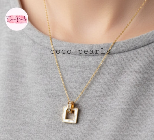 Coco Pearls Stainless Steel Anti Tarnish Gold dainty elegance necklace with a white square pendant on a gray background