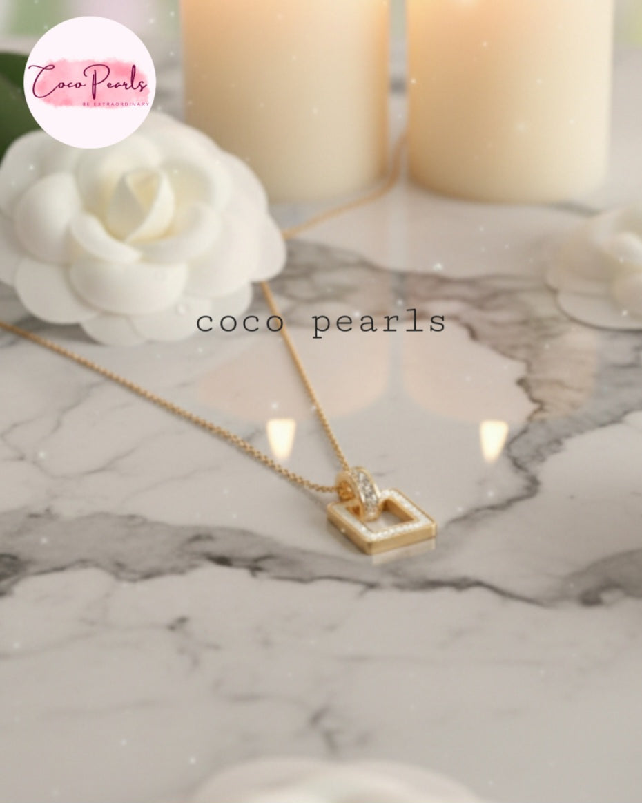 Coco Pearls Stainless Steel Anti Tarnish Gold dainty elegance necklace with a white square pendant on a marble surface