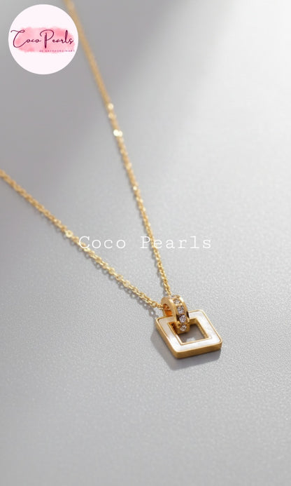 Coco Pearls Stainless Steel Anti Tarnish Gold dainty elegance necklace with a white square pendant on a gray background