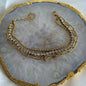 Coco Pearls Stainless Steel Anti Tarnish Gold chain and crystal bracelet on a gray stone surface