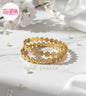 Coco Pearls Stainless Steel Anti Tarnish Gold daisy bloom floral bangle bracelet  on a white surface with 