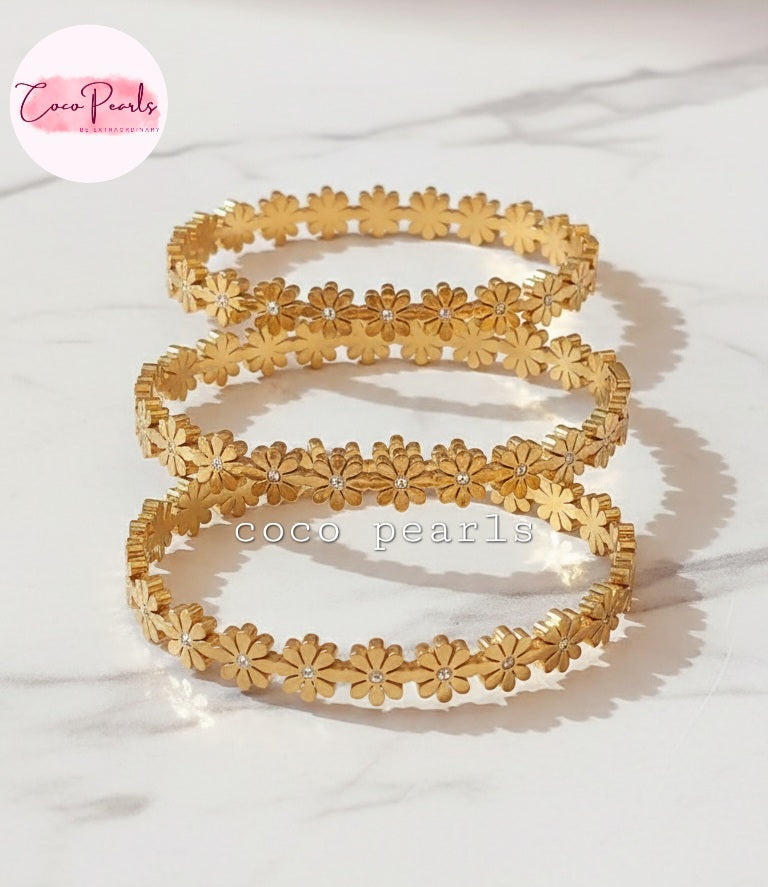 Coco Pearls Stainless Steel Anti Tarnish Gold daisy bloom floral bangle bracelet Set of gold floral bangles on a white background 