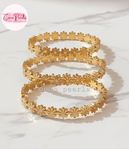 Coco Pearls Stainless Steel Anti Tarnish Gold daisy bloom floral bangle bracelet Set of gold floral bangles on a white background 