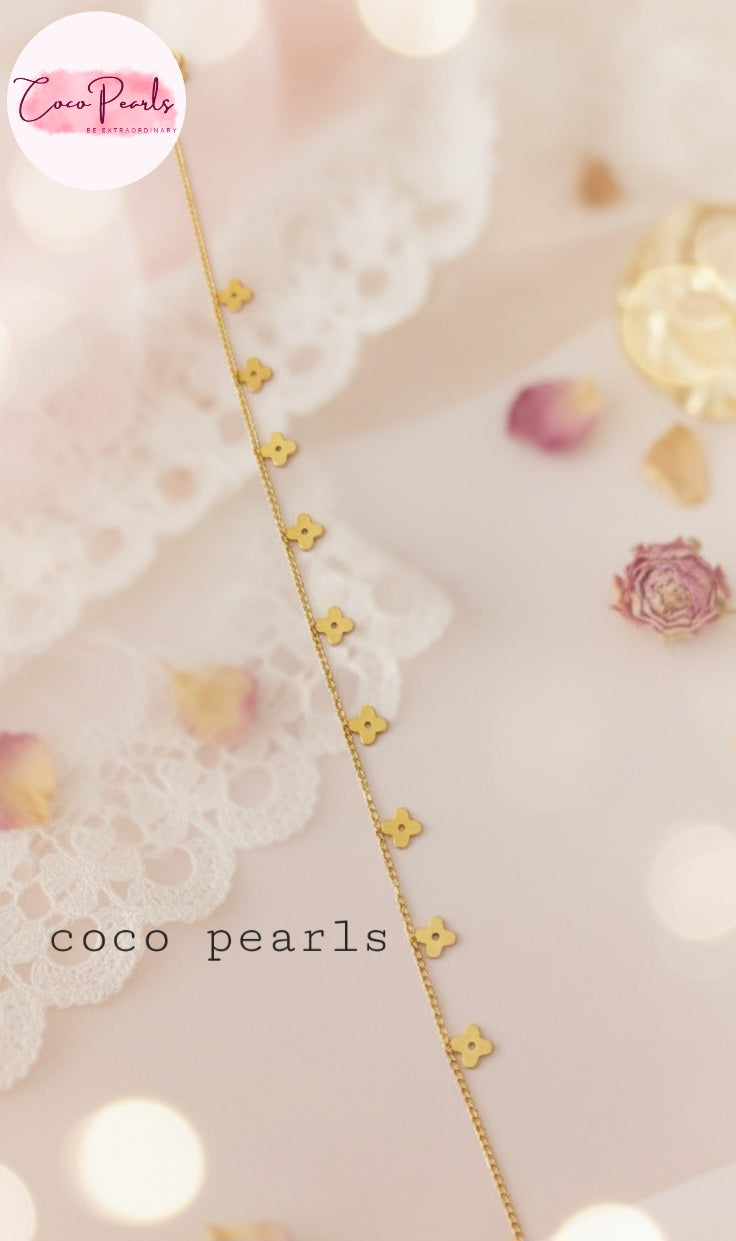 Coco Pearls Stainless Steel Anti Tarnish Gold delight anklet with floral hanging charms on a soft background