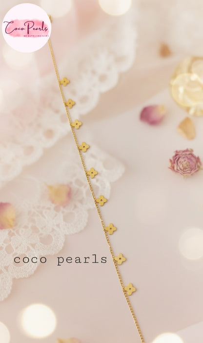 Coco Pearls Stainless Steel Anti Tarnish Gold delight anklet with floral hanging charms on a soft background