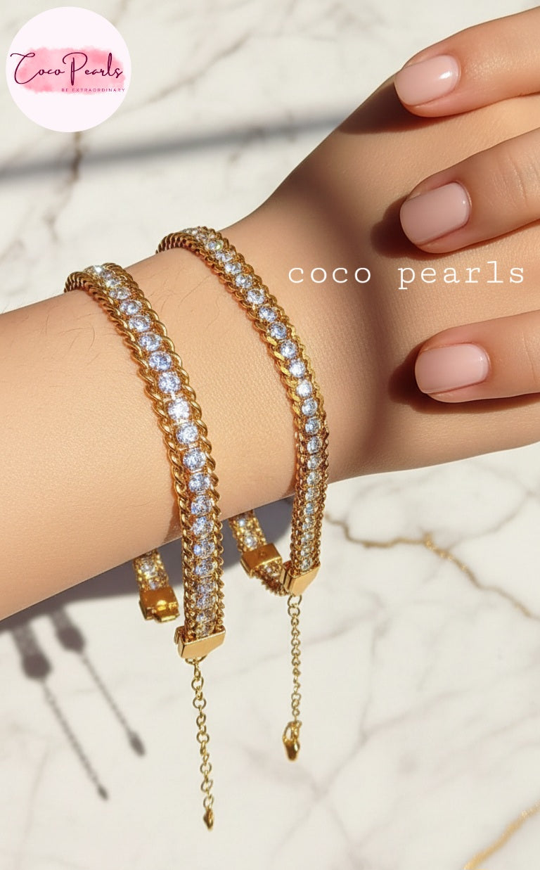 Coco Pearls Stainless Steel Anti Tarnish Gold bracelet with embedded stones on hand one broad chain other medium chain