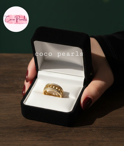 coco pearls stainless steel anti tarnish gold diamond studded with metal chain in center displayed in a jewelry box