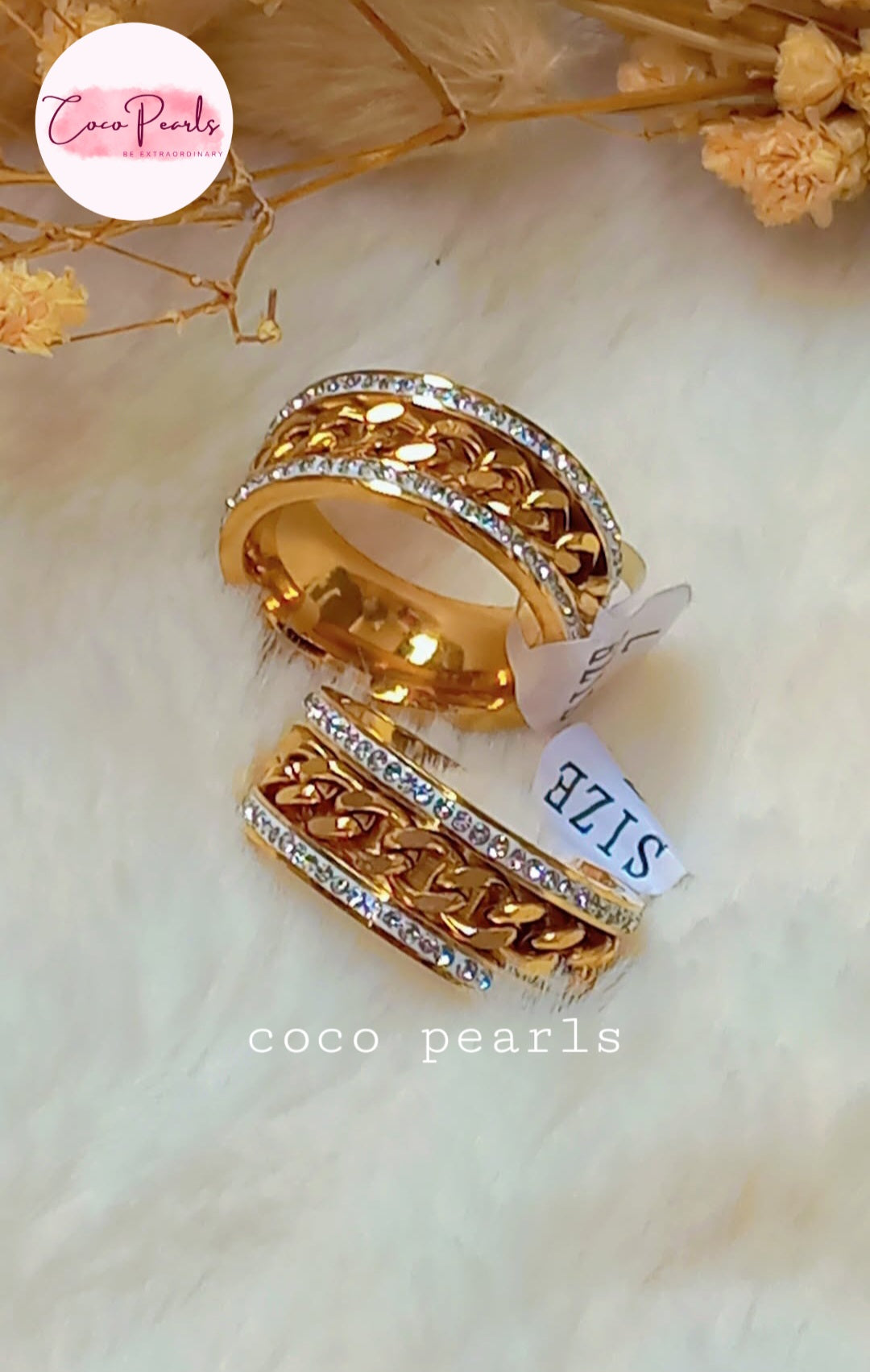 coco pearls stainless steel anti tarnish gold diamond studded with metal chain in center displayed on white fabric