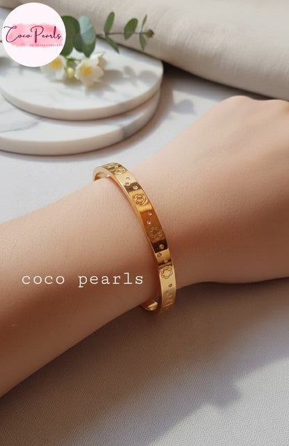 Coco Pearls Stainless Steel Anti tarnish Gold diamond groove handcuff bracelet displayed on a wrist