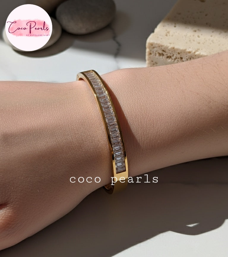 Coco Pearls Stainless Steel Anti Tarnish Gold diamond line handcuff bangle bracelet with clear stones on a wrist
