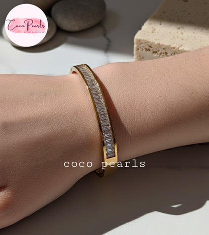 Coco Pearls Stainless Steel Anti Tarnish Gold diamond line handcuff bangle bracelet with clear stones on a wrist