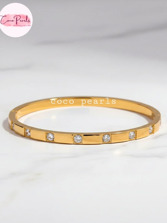 Coco Pearls Stainless Steel Anti tarnish Gold diamond radiance handcuff bracelet with small diamonds on a white background