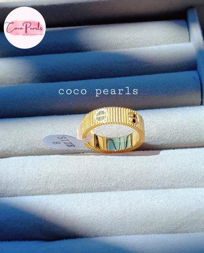 coco pearls stainless steel anti tarnish golden diamond striped ring displayed on a light background