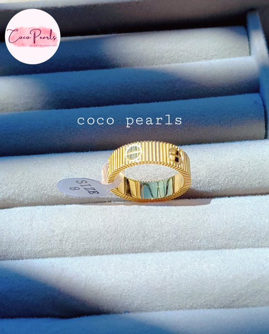 coco pearls stainless steel anti tarnish golden diamond striped ring displayed on a light background