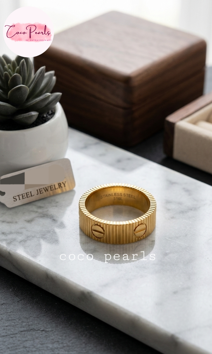 coco pearls stainless steel anti tarnish golden diamond striped ring displayed on a marble surface