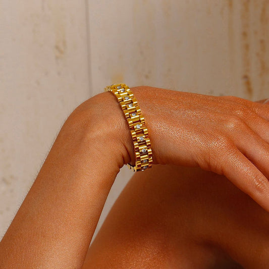 Coco Pearls Stainless Steel Anti Tarnish Gold diamond watch bracelet on a wrist against a neutral background