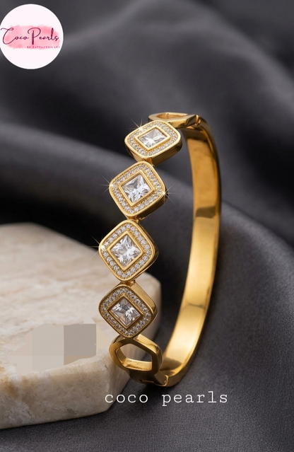 Coco Pearls Stainless Steel Anti Tarnish Gold diamond accent handcuff bangle bracelet with diamond-like stones on a white background