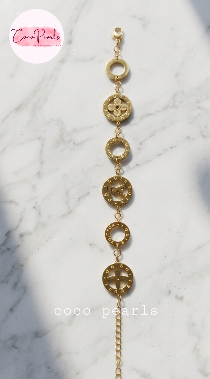 Coco Pearls Stainless steel anti tarnish Gold disc bracelet on a white marble surface