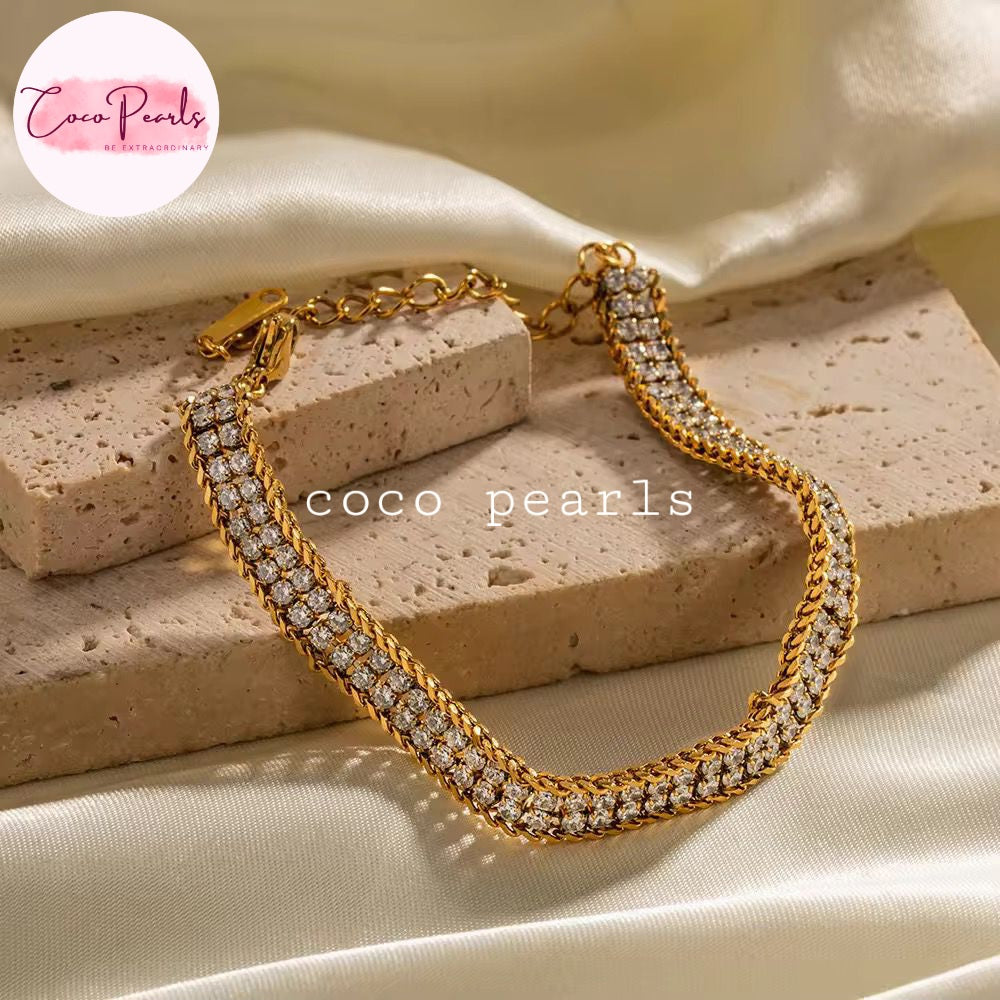 Coco Pearls Stainless Steel Anti Tarnish olden Radiance bracelet with two rhinestone lines displayed on textured background