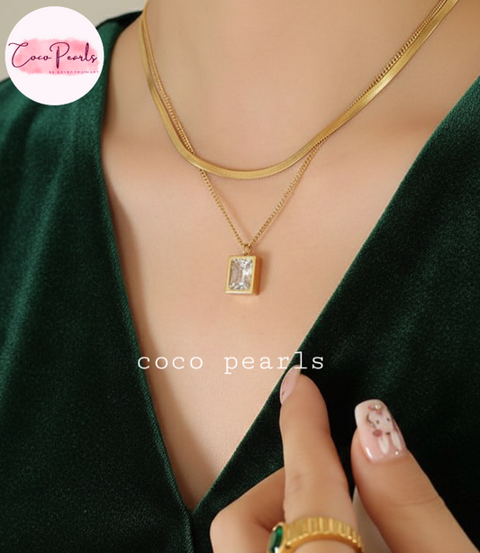 coco pearls stainless steel anti tarnish gold dual elegance necklace which snake chain and simple chain and a rectangular hanging charm 