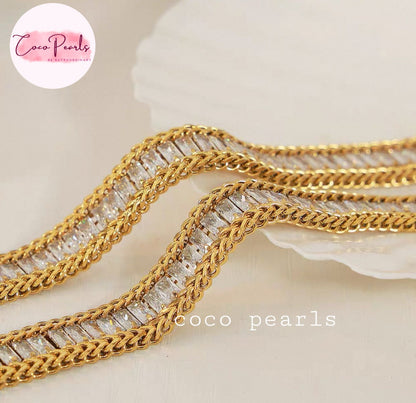 Coco Pearls Stainless Steel Anti Tarnish Gold elegant twist bracelet  with clear stones on a beige background