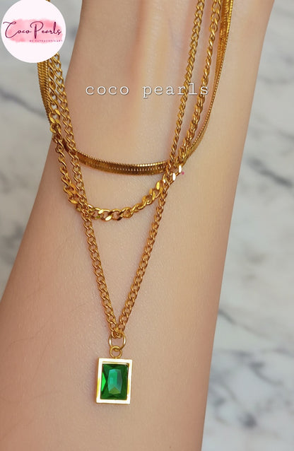 Coco Pearls Stainless Steel Anti Tarnish Gold emerald trio triple chain necklace with a green pendant displayed on hand