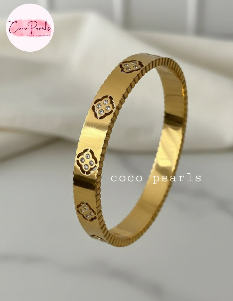 Coco Pearls Stainless Steel Anti tarnish Gold eternal bloom handcuff bangle bracelet with diamond accents on a light background