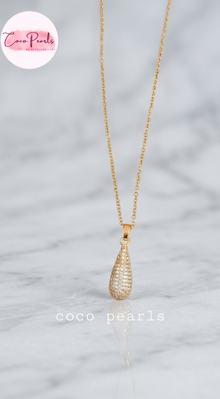 coco pearls stainless steel pakistan anti tarnish waterproof Gold eternal drop necklace with diamond studded drop pendant on a light background