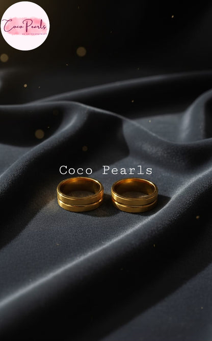 Coco Pearls Stainless Steel Anti Tarnish eternal ring.Two gold rings bands on black fabric