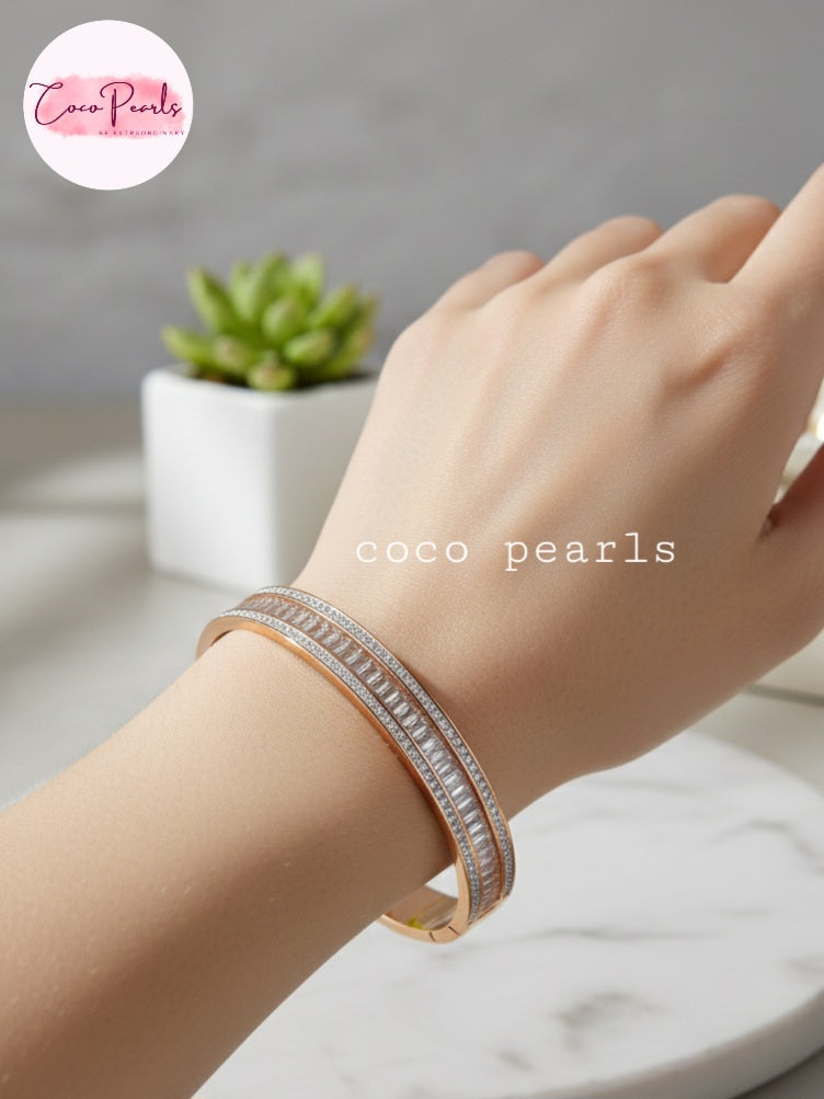Coco Pearls Stainless Steel Anti tarnish Gold Eternal Spark Handcuff bangle bracelet with zircon and diamonds studded displayed on hand