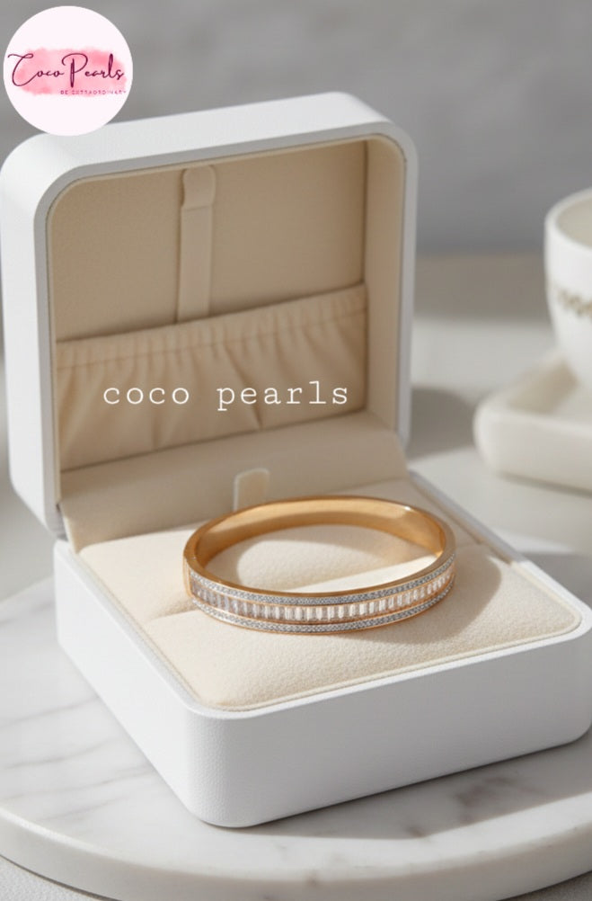 Coco Pearls Stainless Steel Anti tarnish Gold Eternal Spark Handcuff bangle bracelet with zircon and diamonds studded displayed in a jewelry box