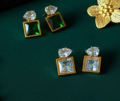Coco Pearls Stainless Steel Anti Tarnish Gold gem earrings with green and clear gemstones on a green background