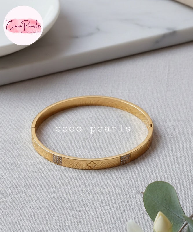 Coco Pearls Stainless Steel Anti tarnish Gold Gleam Hinged Handcuff Bangle bracelet with floral and diamond design