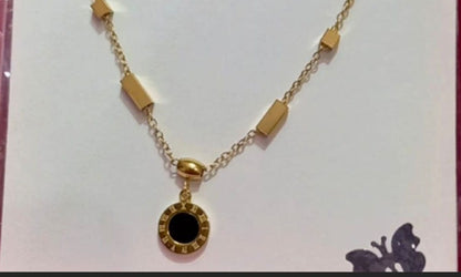 Coco Pearls Stainless steel anti tarnish Gold geometry bracelet with black gemstone hanging displayed on a white background,