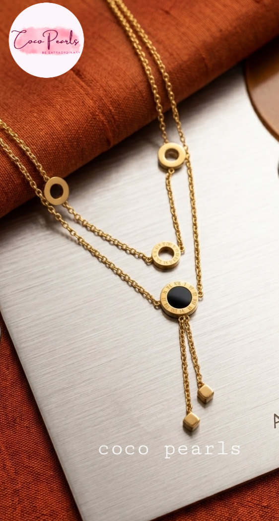 Coco Pearls Stainless Steel Anti Tarnish Gold chain cascade necklace with a black and gold circles and two hangings on a white background