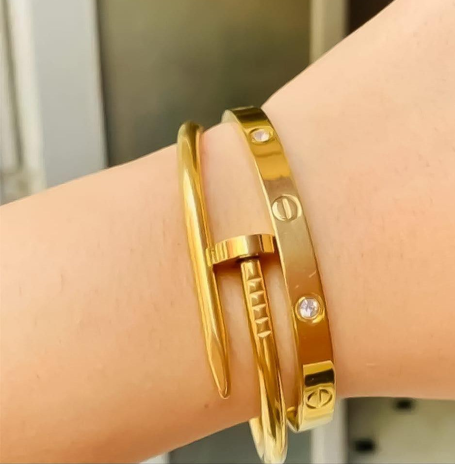 Coco Pearls Stainless Steel Anti Tarnish Golden luxe bracelet combo with cartier and nail handcuffs combo on a wrist against a neutral background