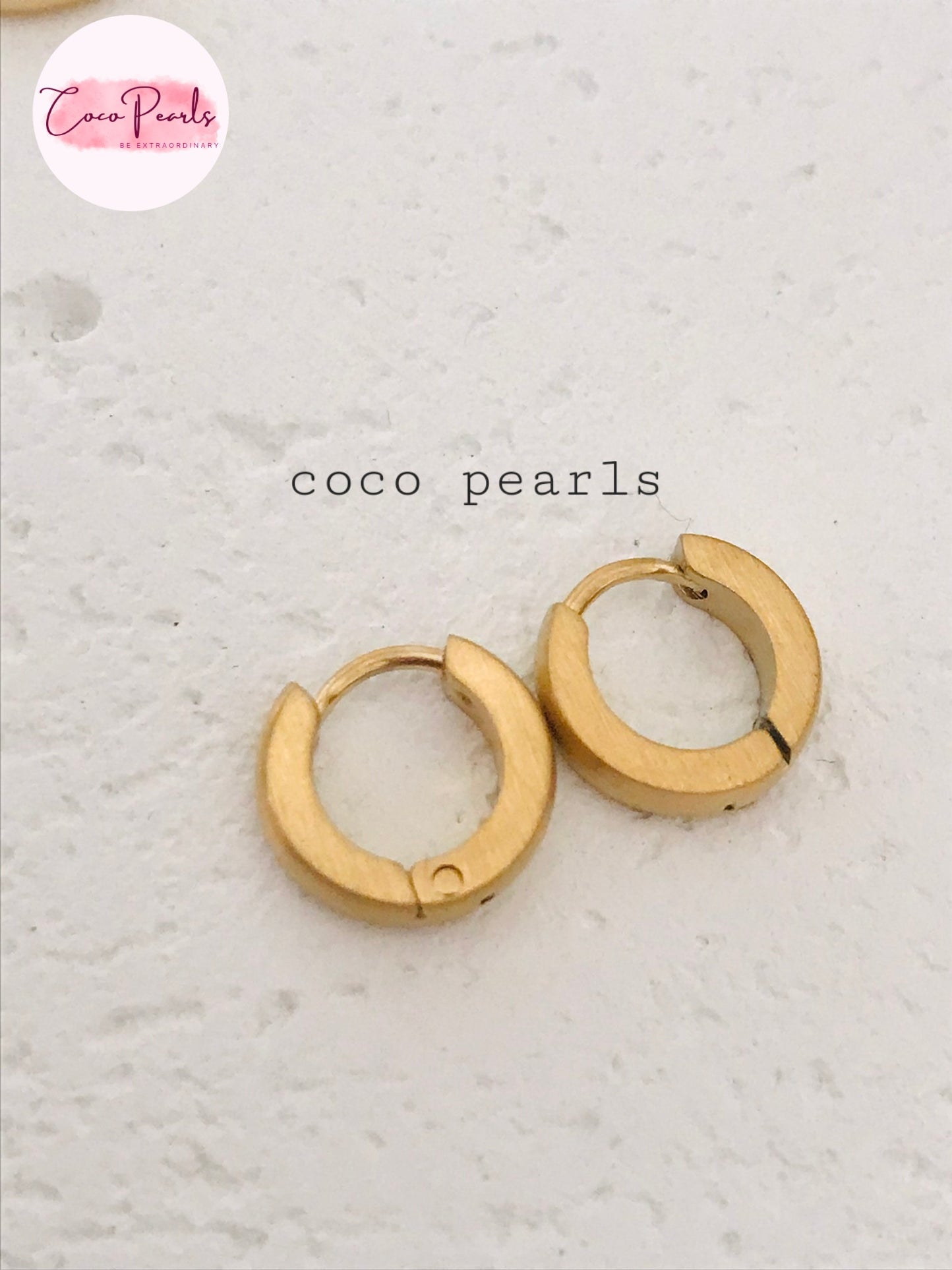 Coco Pearls Stainless Steel Anti Tarnish Golden barrel hoop earrings on a simple background