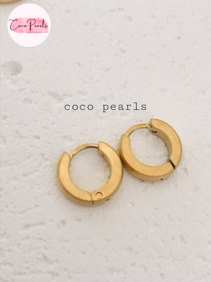 Coco Pearls Stainless Steel Anti Tarnish Golden barrel hoop earrings on a simple background