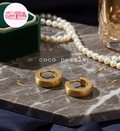 Coco Pearls Stainless Steel Anti Tarnish Golden barrel hoop earrings on marble top