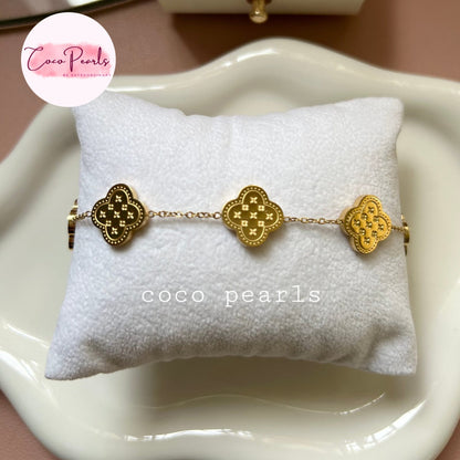 Coco Pearls Stainless steel Anti Tarnish Golden fortune bracelet with clover-shaped charms on cushion