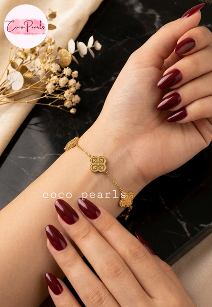 Coco Pearls Stainless steel Anti Tarnish Golden fortune bracelet with clover-shaped charms on wrist
