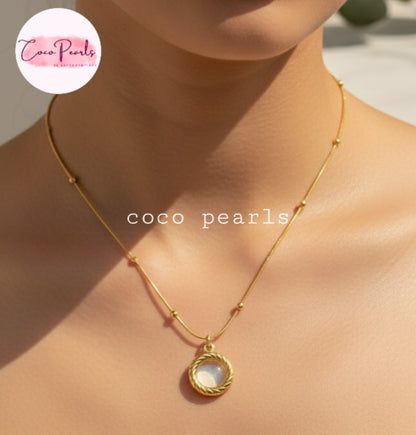 Coco Pearls Stainless Steel Anti Tarnish Golden oasis necklace with a pendant on a person's neck