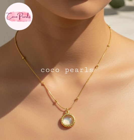 Coco Pearls Stainless Steel Anti Tarnish Golden oasis necklace with a pendant on a person's neck