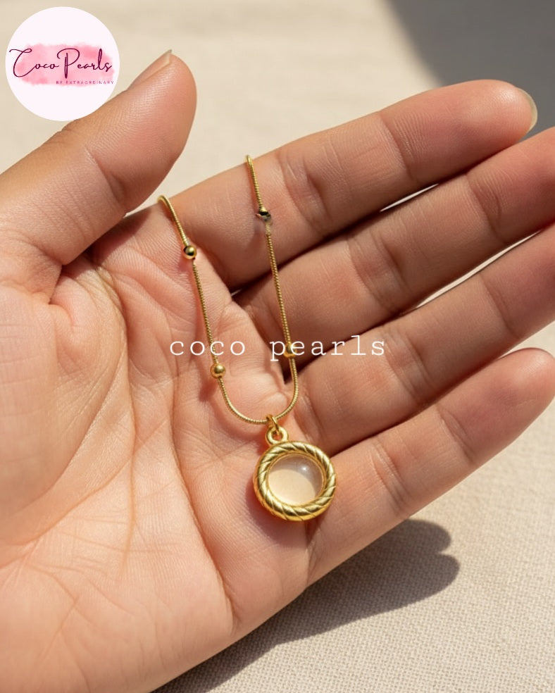 Coco Pearls Stainless Steel Anti Tarnish Golden oasis necklace with a pendant on hand
