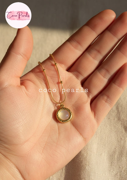Coco Pearls Stainless Steel Anti Tarnish Golden oasis necklace with a pendant on hand