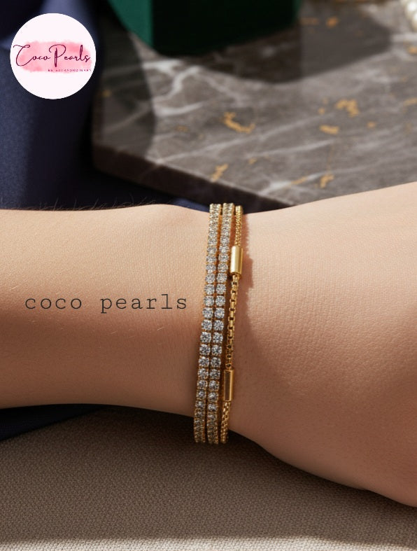 Coco Pearls Stainless steel Anti Tarnish Golden stream link bracelet with double layer chain. a diamond studded line and golden chain displayed a wrist