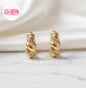 Coco Pearls Stainless Steel Golden whirl hoop croissant shaped earrings with rhinestones on a marble surface